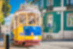 Yellow tram 28 on streets of Lisbon, Portugal on a vibrant day