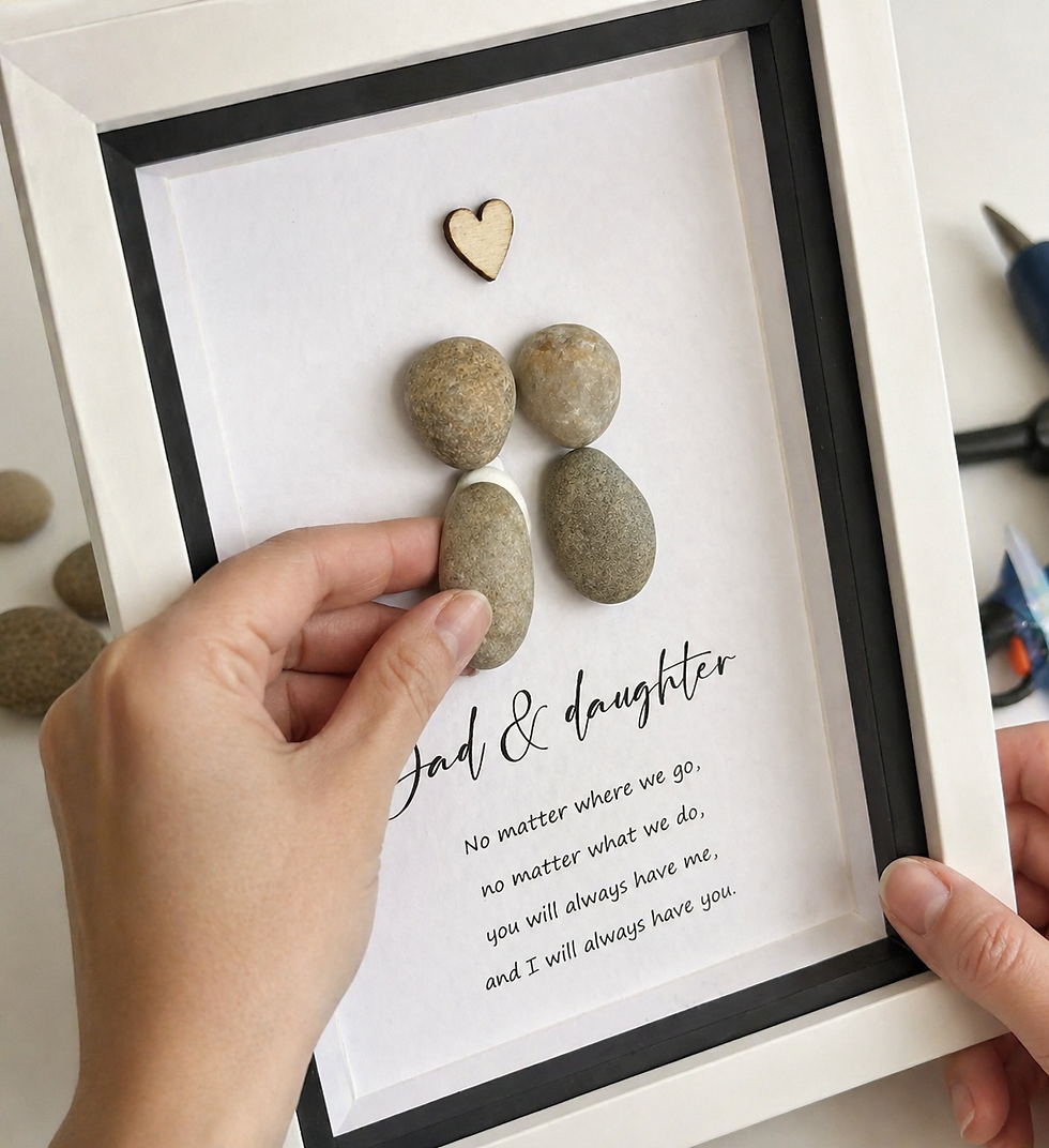 Close-up view of a craftsman adding gold foil lettering to a framed print