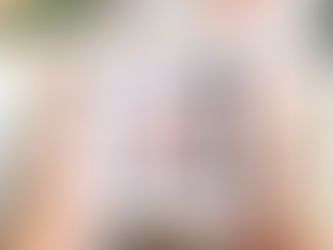 A pair of hands holding a white picture frame, the frame has a wooden picture inside it showing a house, and wording that reads 'New Home'