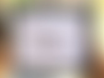 A selection of pebbles depicting a family placed within a picture frame to create a family gift