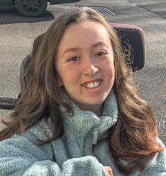 Avery outside in grey jumper