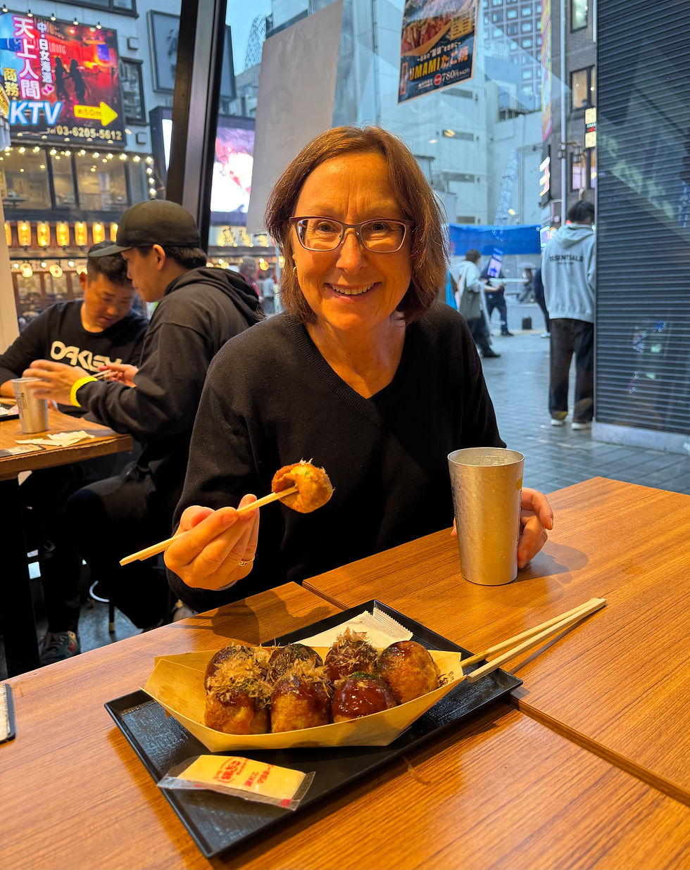Trying takoyaki and a lemon refresher after a busy day of walking in Tokyo
