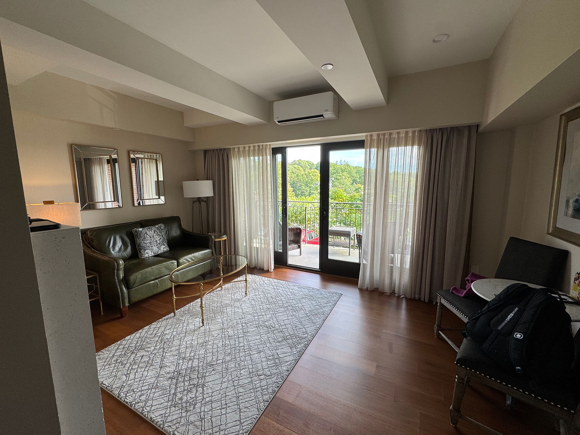 A lovely sitting area with a balcony overlooking the water.