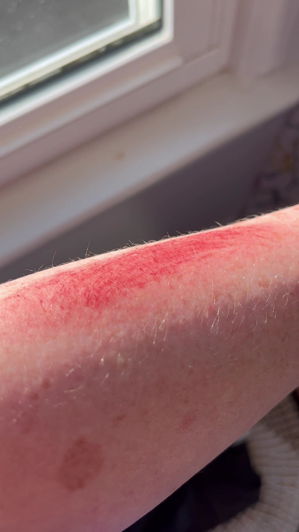 Thumbnail: Sheer swatch of Hibiscus Ginger Sheer Tinted Lip Balm on skin showing subtle ruby tint