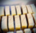 Hand-cut traditional Castile olive oil soap bars curing on rack during extended cold process aging at Apothecary Addict
