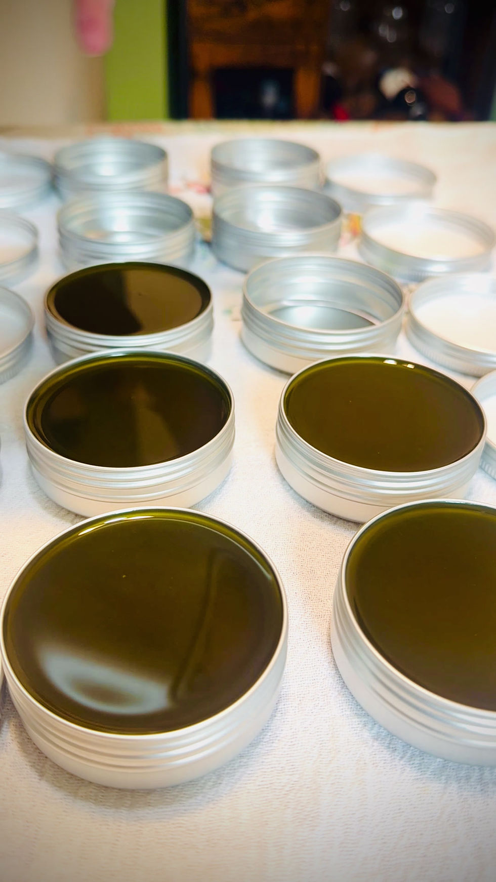 Thumbnail: Freshly poured North Star Anointing Balsam cooling in tins with warm resinous texture