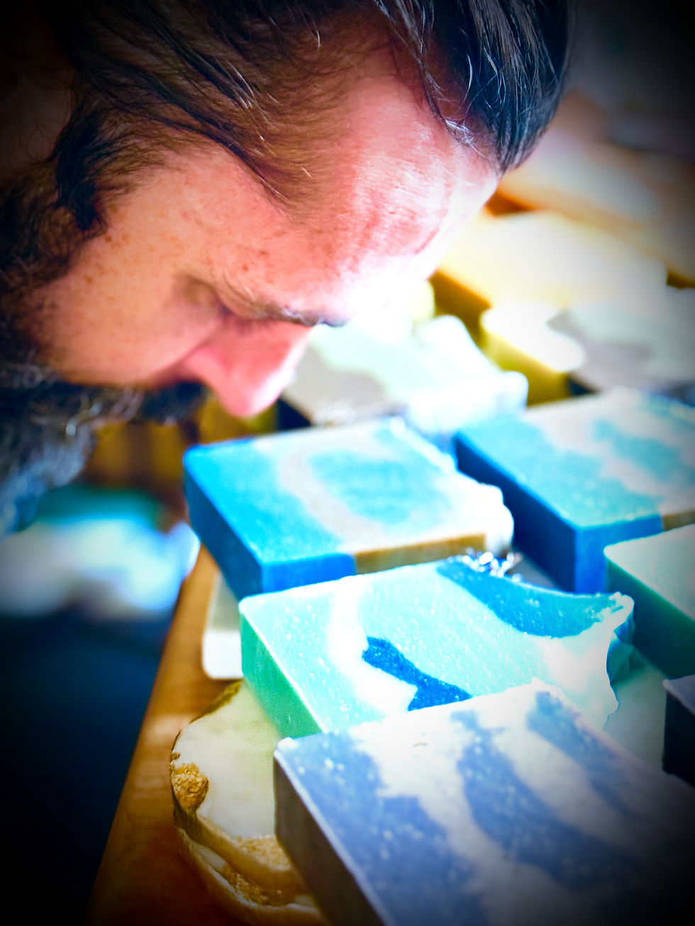Close inspection of handmade soap bars during small-batch production highlighting craftsmanship and quality control