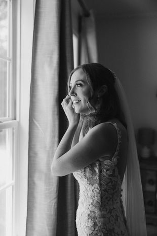 Katherine putting on the final touches while getting ready at Haven for her weddings.