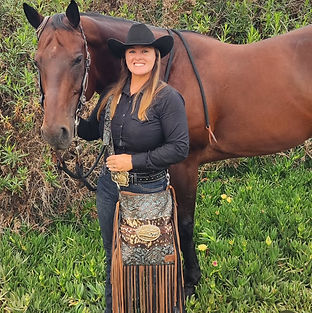 Handcrafted leather crossbody bag with intricate tooling and fringe