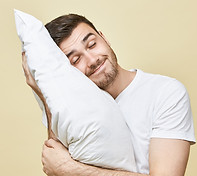 horizontal-image-handsome-cute-young-man-with-bristle-posing-with-head-white-soft-pillow-s