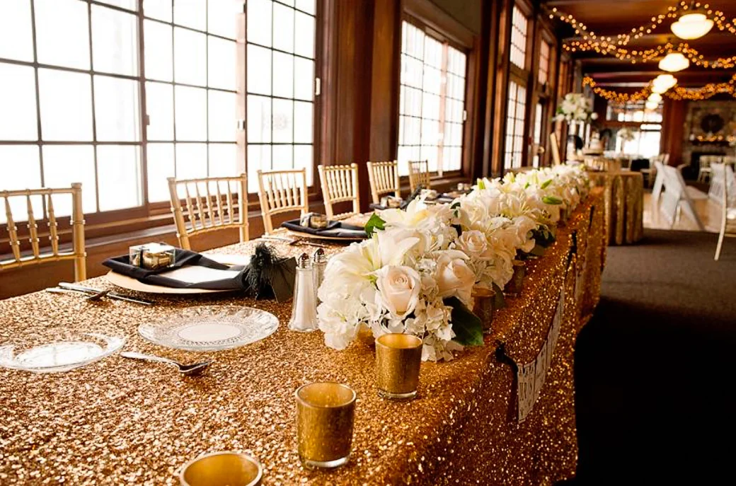 wedding head table with gold sequin glitz table linen sparkling in the light