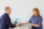 ADHD Career Coach Nat Harrison at a desk coaching a client transitioning in their career.