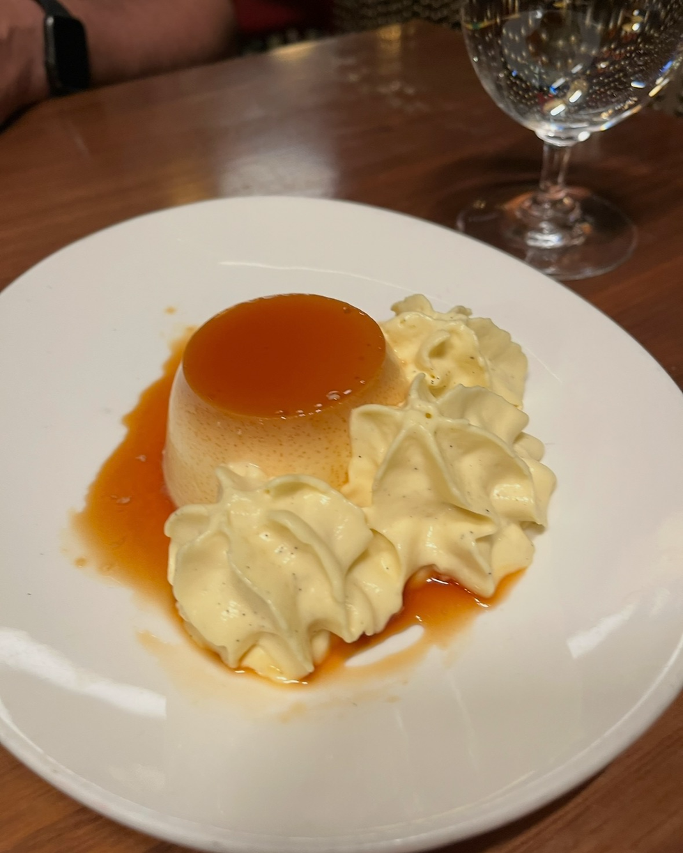 Flan mamá Marisa - A Jaleo Favorite with a classic egg custard profile topped with whip cream and a Carmel sauce
