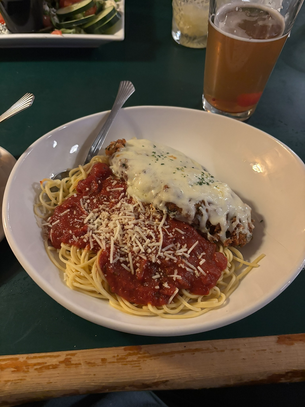 The Chicken Parmesan - Breaded chicken breast over angel hair pasta, topped with marinara and mozzarella cheese.