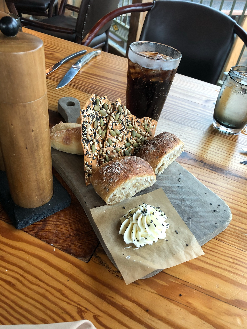 The Bread Service W/ Truffle Butter and green lentils seeds