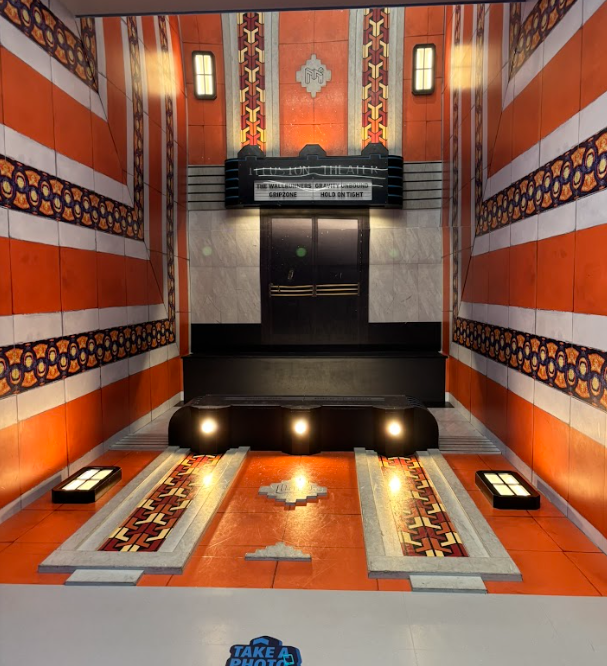 If you lay down by the entry, you will show up in front of the theater. Just like Magic!