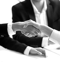 two people shaking hands in front of a l
