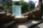Cylindrical water fountain with concrete base and benches