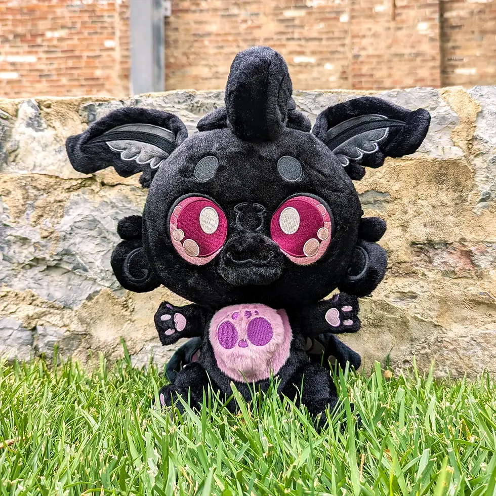 Thumbnail: Black Monty Mothman Plush, Front View, Wearing Apron, Thermometer, wooden spatula, candle and measuring cup plush props