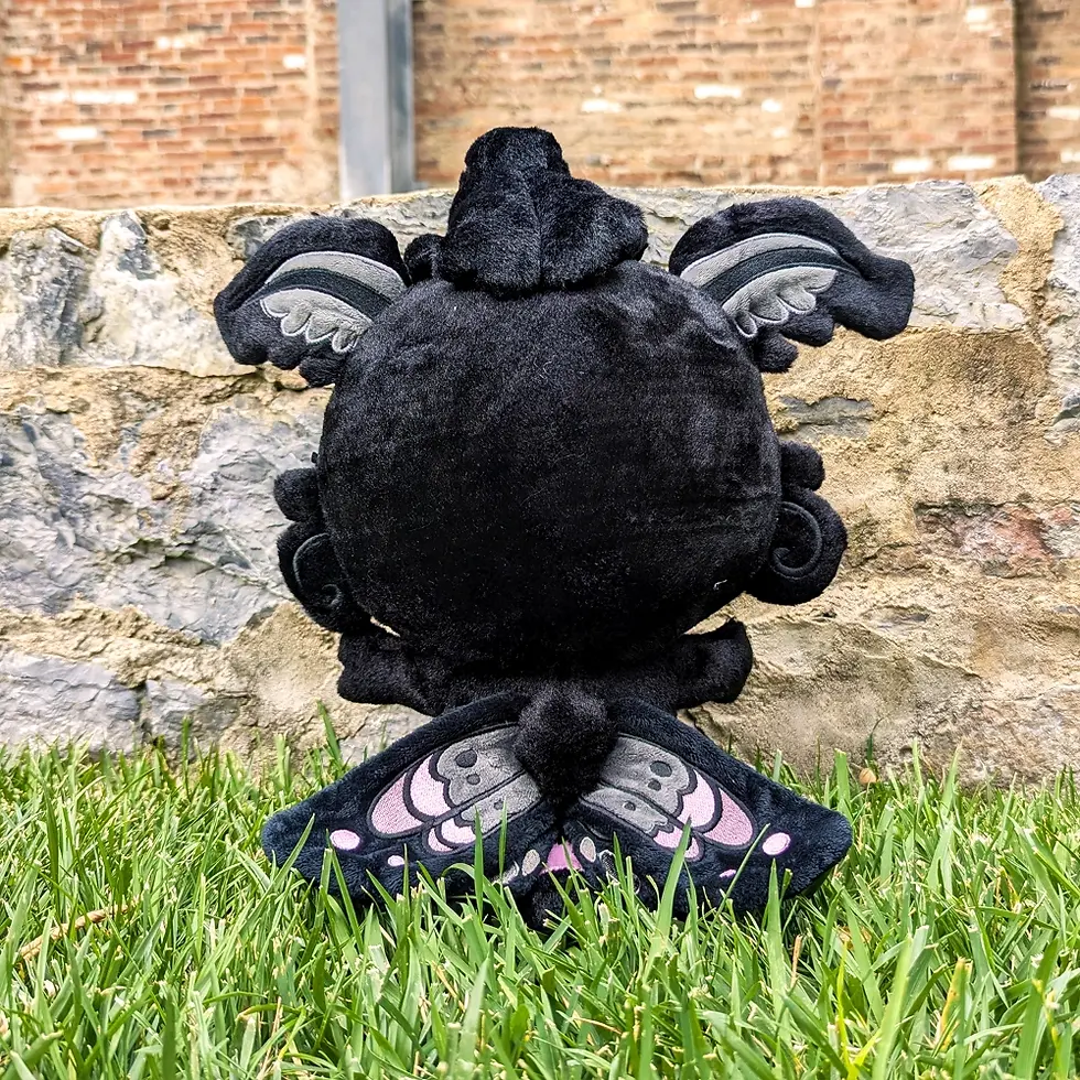 Thumbnail: Black Monty Mothman Plush, Front View, Wearing Apron, Thermometer, wooden spatula, candle and measuring cup plush props