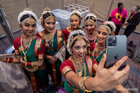 a group of women are taking a selfie with a cell phone