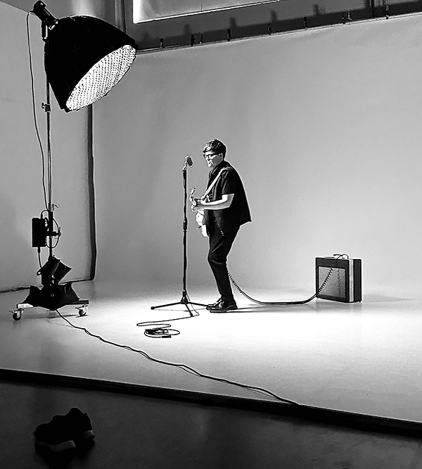 Musician performing on set during a filmed production, supported by Jack Fox Media’s Vancouver-based film and television production team.
