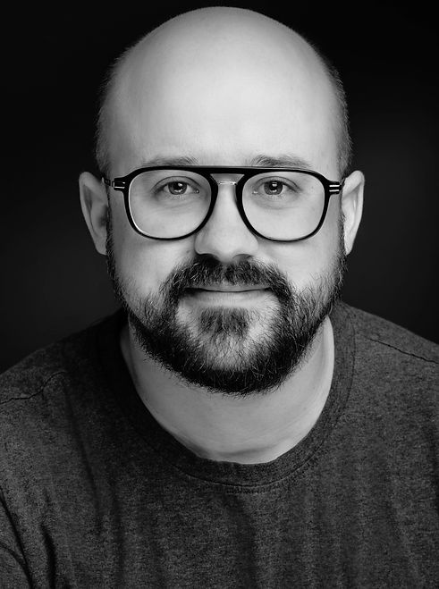 Black and white portrait of Jack Fox, a Vancouver film and TV producer specializing in unscripted television, documentary storytelling, and collaborative production leadership.
