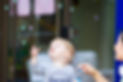 Toddler discovering bubbles during sensory play at Bambini House early learning centr