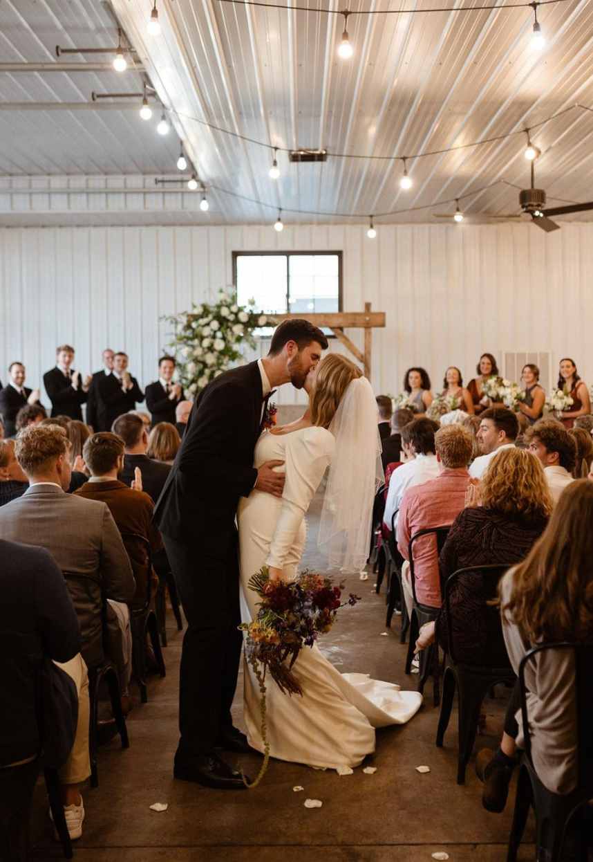 bride-groom-kissing-wedding-aisle.jpg