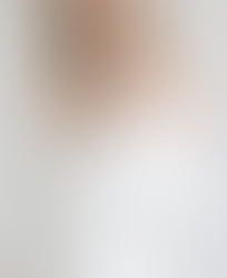 White silk wedding dress with a pointed strapless neckline and pearls