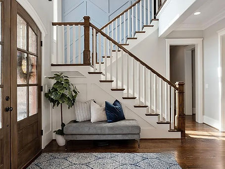 Gorgeous traditional entryway with beautiful staircase by local interior designer