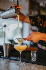 cocktail guy pouring a cocktail in ibiza. pornstar martini with a shot of Prosecco.