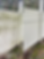 Before and after vinyl fence cleaning in Indianapolis, showing the removal of green algae and dirt grime.