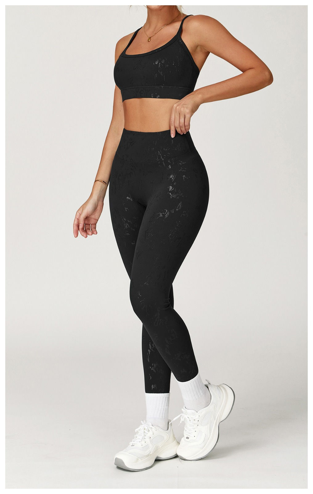 ull-body black activewear set with tonal pattern, includes Midnight Noir bra and leggings by BÜNDA BUTT, modeled front view