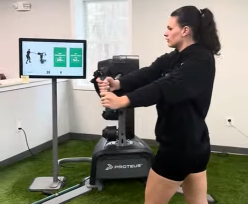 Athlete using Proteus motion training machine to analyze and improve baseball throwing mechanics beyond traditional pitching drills.