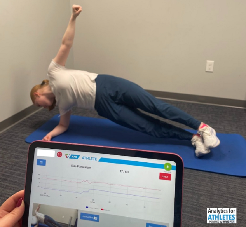 Athlete performing side plank core stability testing with real-time biomechanics data, emphasizing tissue readiness and foundational strength before increasing training intensity.