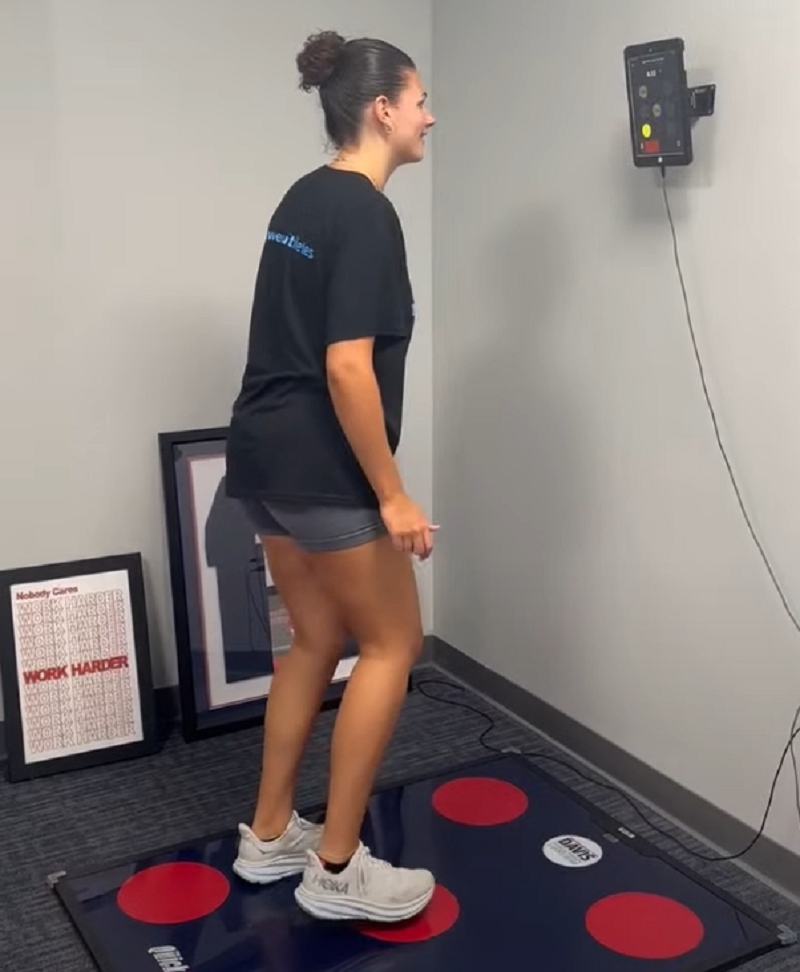 Athlete using the QuickBoard visual reaction system at Analytics for Athletes to train recognition speed and improve the ability to spot film cues for defensive lacrosse play.