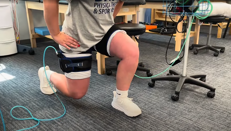 Athlete performing a lunge exercise with blood flow restriction therapy bands, demonstrating how repetitive strain without recovery can contribute to overuse injuries.