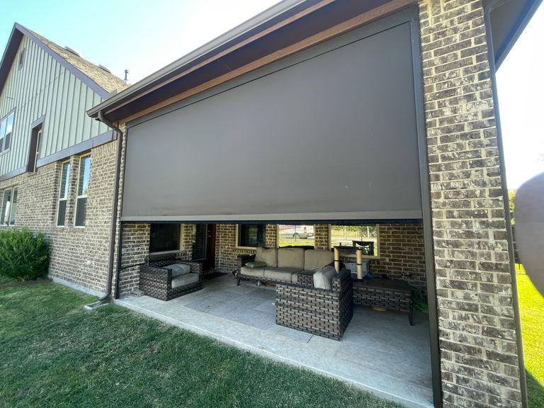Outdoor patio with an exterior roller shade