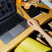 Marketing Professionals Sat at Laptop busy over having lunch at desk