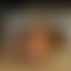 Rustic copper mug on wooden table with lemon and lime wedges. Background shows another mug and a crate labeled "HANDLEBEND." Warm ambiance.