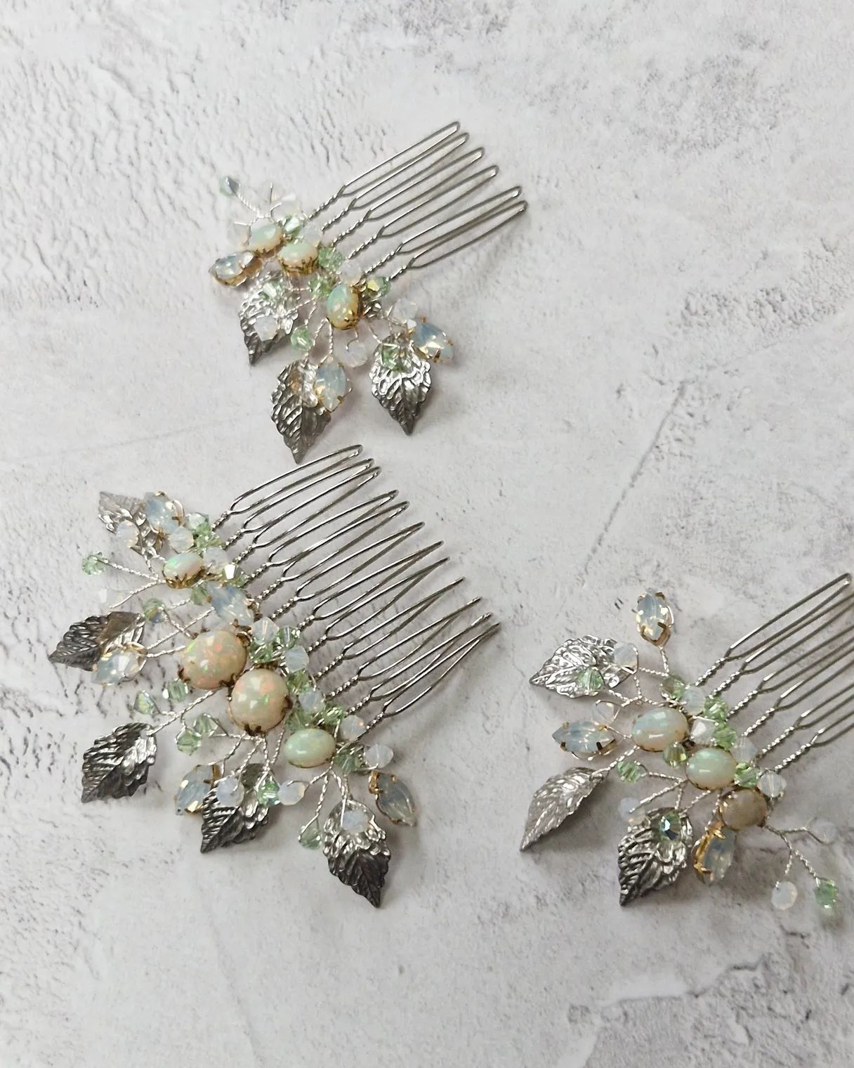 a trio of bridal combs made with reworked vintage opals from the clients grandmother