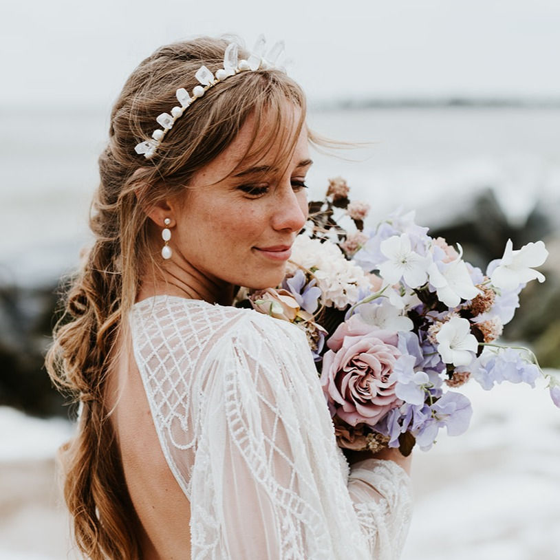 bride wearing short freshwater pearl and mother of pearl bridal drop earrings