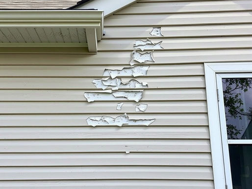 hail damage on the siding of a house