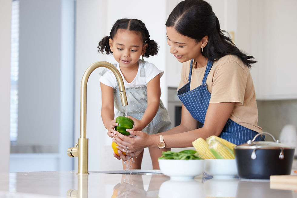 Mom and daughter washing fresh vegetables