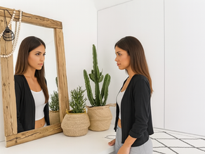 A woman looking at her reflection in the mirror, represents self-projection