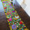 Thumbnail: Table runner with Flowers  in a green olive  tone and multicolor embroidered 