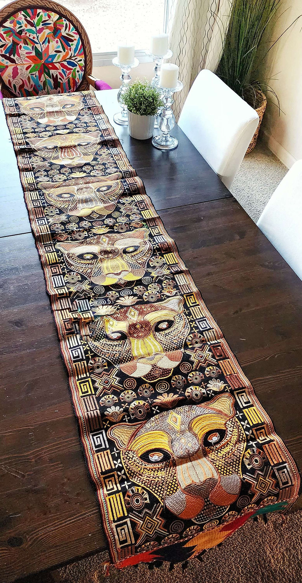 Tab le runner with jaguars faces machine embroidered from Guatemala.