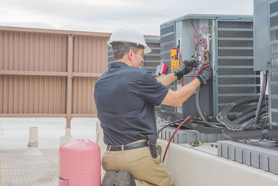 Burban Air Systems Ltd. HVAC Tech Checking Condenser