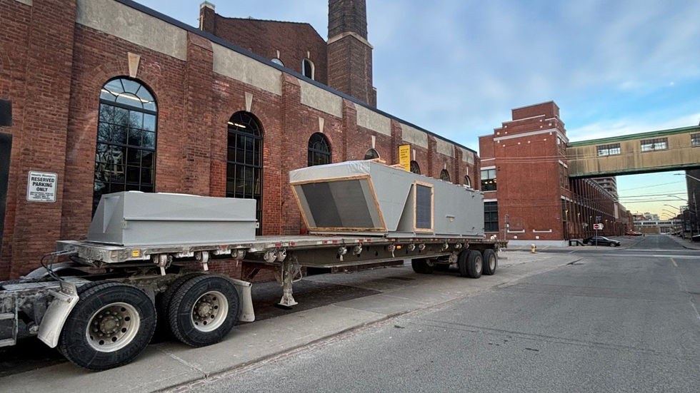 Large rooftop air-handling unit set by mobile crane on a heritage brick building (photo 11)